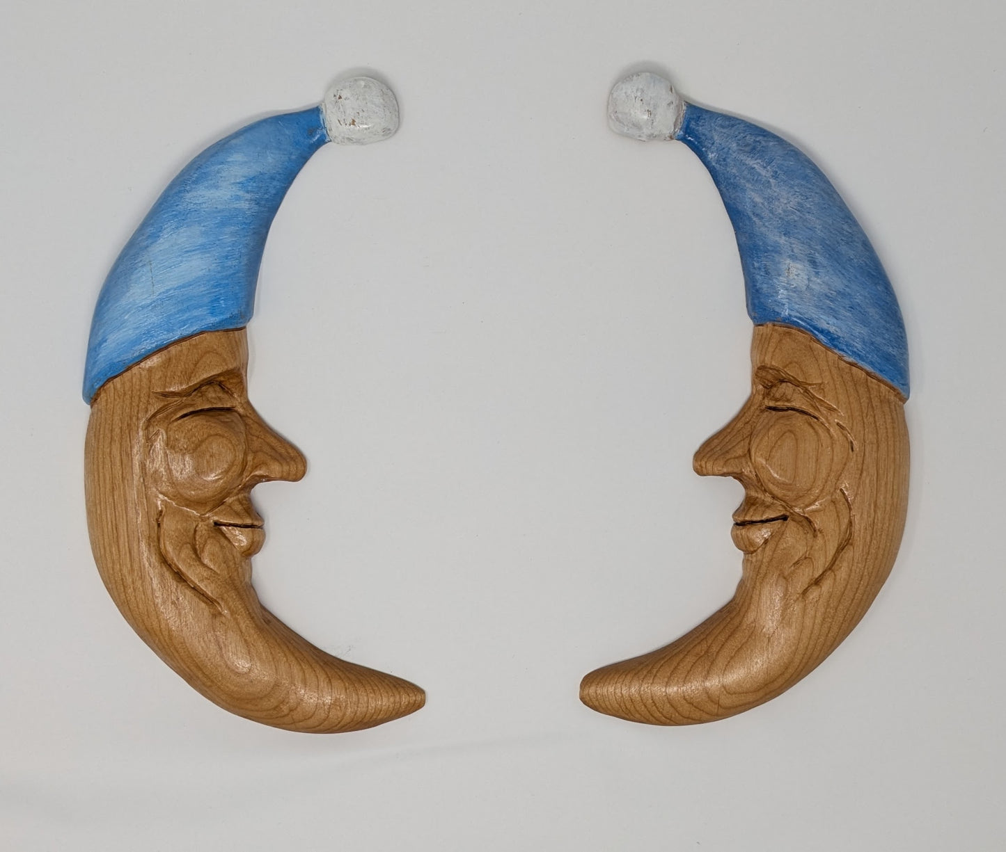 Twin hand carved wooden moons for hanging as wall art in the nursery and kid's rooms